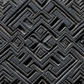 Intricate geometric pattern of ancient carved stone with repeating labyrinthine motifs and deep textures photo