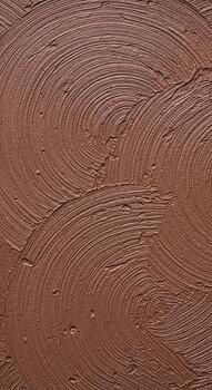 Textured abstract background with rippling concentric circles in earthy tones of brown and red photo