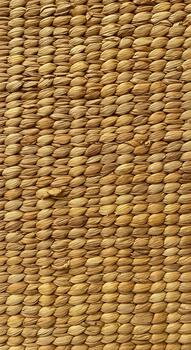 Close up textured view of a woven natural straw mat with horizontal and vertical woven strands creating a rustic pattern photo