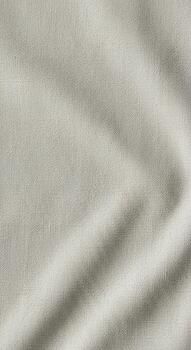 Softly lit textured fabric with subtle shadows creating a gentle diagonal pattern photo