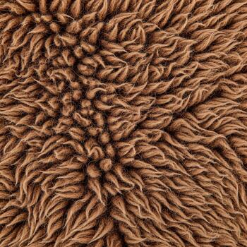 Close up abstract texture of a fuzzy brown material with a dense swirling pattern creating a sense of depth and warmth photo