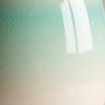 Abstract textured background with soft pastel green and white gradients and subtle light reflections creating a serene and airy atmosphere photo