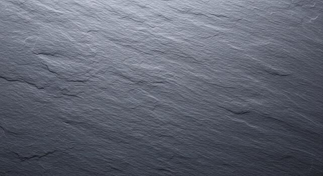 Close up textured background of natural dark grey slate stone with subtle linear patterns and variations photo