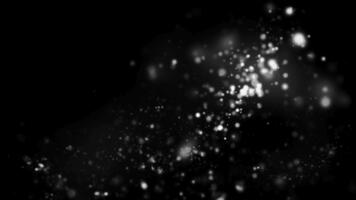 abstrakt bild av lysande vit partiklar spridd mot en mörk svart bakgrund design element video