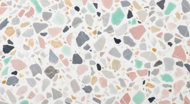 A close up abstract view of a pastel terrazzo pattern with irregular chips of various colors on a white background photo