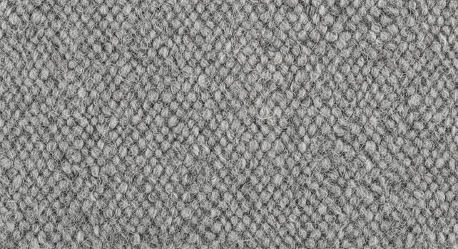 Close up textured abstract background with a repeating pattern of small irregular shapes in grayscale tones photo