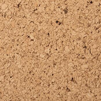 Close up view of a textured natural cork surface with small dark flecks and variations in color ideal for backgrounds photo