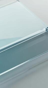 Close up abstract view of a clear glass surface with subtle reflections and a hint of blue tint photo