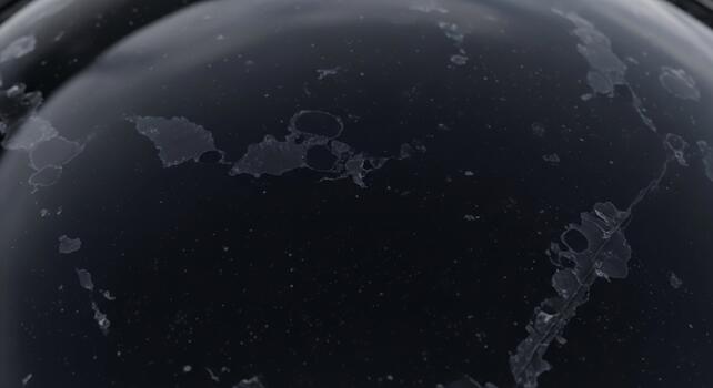 Close up microscopic view of a dark textured surface with intricate patterns and speckles of light photo