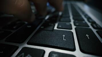 Slow motion closeup of typing on laptop keyboard with a clear press of the enter key, showing tactile motion and digital workflow video