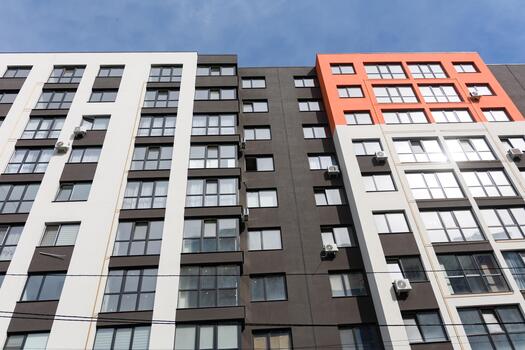 Modern apartment building showcases sleek architecture and vibrant colors, blending style and functionality in a lively urban setting photo