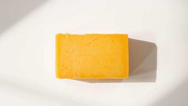 Golden Rectangular Form on Light Surface, Play of Light and Shadows, Minimalistic Composition. photo