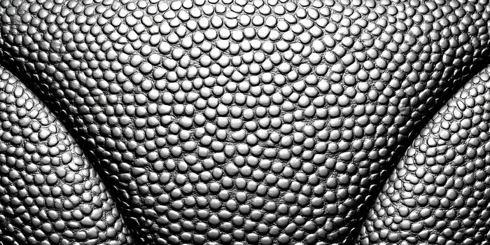 A close up abstract pattern of a gray bumpy texture with subtle folds and variations in light and shadow photo