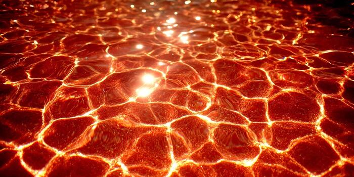 A vibrant abstract pattern of red water ripples with bright light reflections creating a lava like texture photo