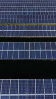 Renewable energy shines brightly in a vast solar power field under clear blue skies with rows of panels strategically placed for maximum efficiency and sunlight capture video