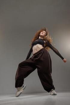 Jazz Funk Dancer in Urban Style Showing Dynamic Modern Dance Pose with Expressive Movement photo