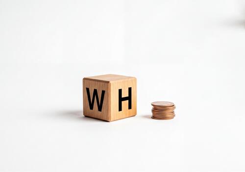 Work and Home Concept Displayed on Wooden Cube with Arrow and Stack of Coins for Income photo