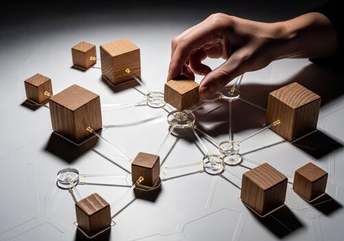 Hand Placing Wooden Cube on Network Structure Representing Connection and Strategy photo