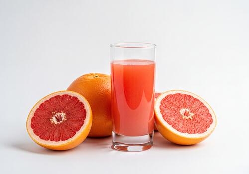 Vibrant Refreshing Pink Grapefruit Juice with Fresh Whole and Sliced Citrus Fruits on White Background photo