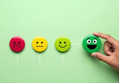 Hand selecting happy emoji for customer satisfaction survey feedback rating scale photo