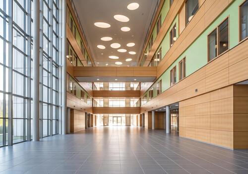 Spacious Blurred Hallway in a Modern Building with Natural Light and Architectural Features photo
