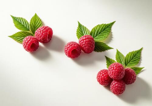 Fresh Red Raspberries with Green Leaves on a Clean White Background, Top View photo