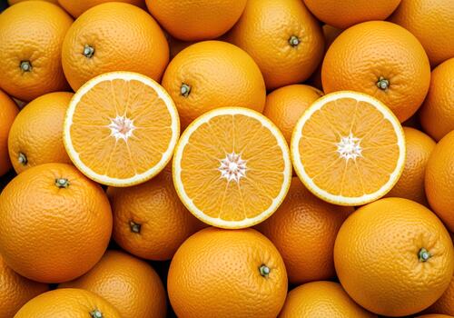 Vibrant Close Up of Fresh Juicy Oranges and Sliced Halves Arranged for a Healthy Citrus Fruit Background photo
