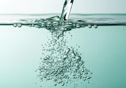 Clear Fresh Water Stream Pouring into Liquid with Abundant Bubbles and Dynamic Splash photo