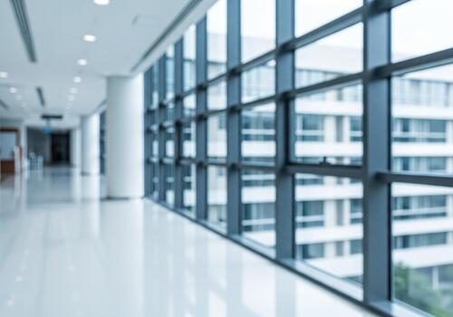 Blurred Modern Office Hallway with Large Windows and Distant Building View photo