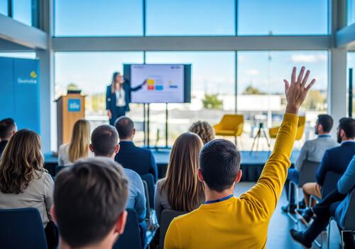 Man Raising Hand at Business Conference Presenter on Screen Discussing Data photo