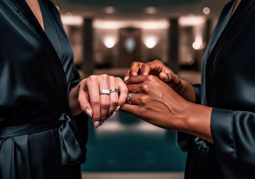 Two Women's Hands Adorned with Rings in an Elegant and Symbolic Gesture of Connection photo
