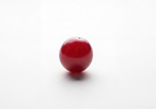 Single Ripe Red Grape on a Clean White Background with Soft Lighting photo