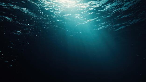 Underwater scene sunlight piercing dark ocean depths for background use photo