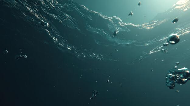 Underwater view with bubbles rising towards the sunlit surface in dark water photo