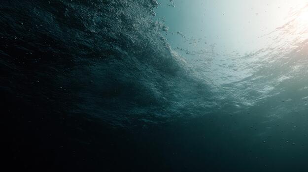 Underwater scene sunlight penetrating deep ocean water creating a textured surface photo