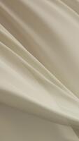 morbido giallo crema tessuto fluente con grazia aria la creazione di elegante minimo struttura sfondo con dolce pieghe liscio superficie e delicato movimento simboleggiante quiete bellezza, e moderno visivo armonia video