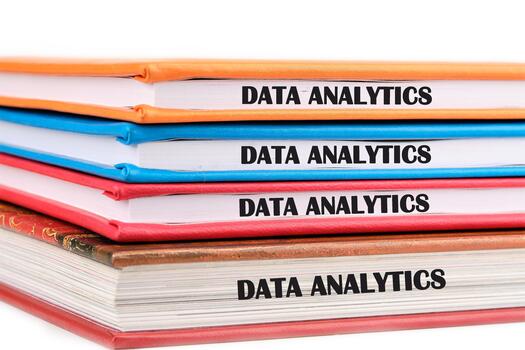 The concept of technology and development. Phrase, words, text DATA ANALYTICS on the ends of the notebooks assembled in a stack photo