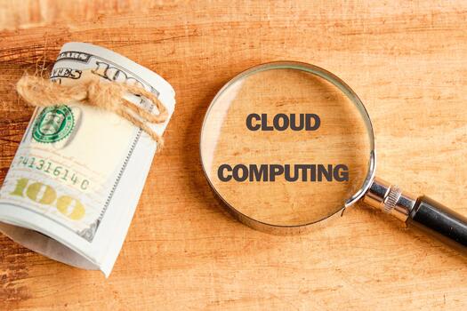 The concept of technology and development. Phrase, words, text CLOUD COMPUTING through a magnifying glass on an antique background, top view photo
