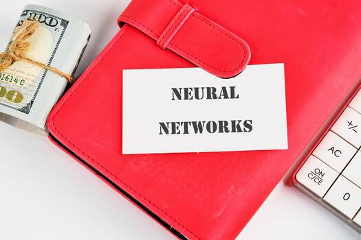 The concept of technology and development. Phrase, words, text NEURAL NETWORKS on a white business card on the background of a red notebook photo