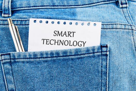 The concept of technology and development. Phrase, words, text SMART TECHNOLOGY API It's written on a piece of paper in my jeans pocket photo