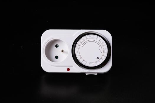 A set of sockets with a timer for lighting power control on a black background photo