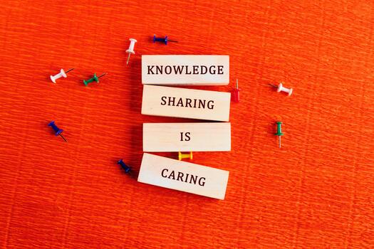 Wooden blocks arranged to convey a meaningful message showcase the importance of sharing knowledge photo