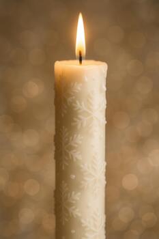 Tall Snowflake Pattern Candle With Warm Flame And Golden Festive Lights photo