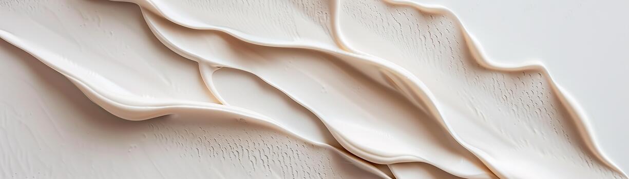 The scene showcases a cream-to-white textured surface with soft, flowing waves that create a calming effect. The subtle shadows enhance the gentle contours, making it visually appealing photo