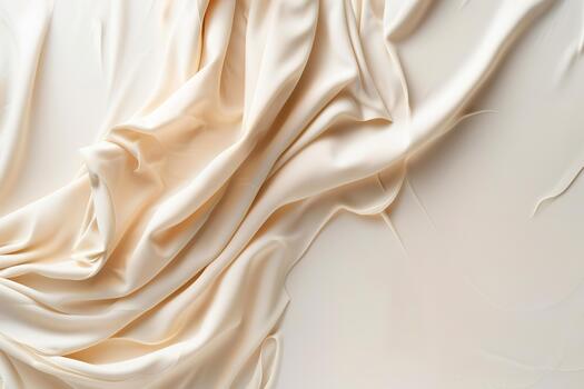 Luxurious cream-to-white fabric smoothly drapes across a simple background, casting tiny shadows. This elegant display highlights texture and soft folds, ideal for artistic setups photo