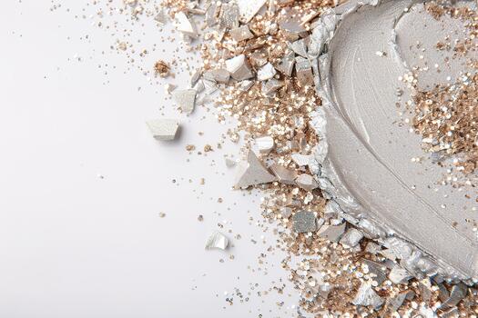 Metallic silver glitter and shiny fragments are scattered across a white surface, creating a vibrant display of sparkle and texture. The scene showcases clean lines and bright reflections photo