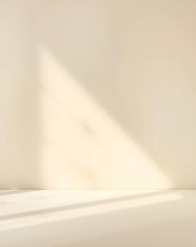 Sunlit empty room with soft, warm window light casting a gentle shadow on a cream wall, serving as a minimal aesthetic background photo