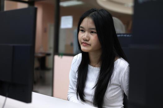 Asian Student Learning on Computer in Classroom Technology Environment photo
