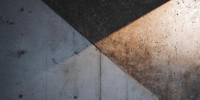 Patterns of light and shadow on textured concrete surfaces during daylight hours photo