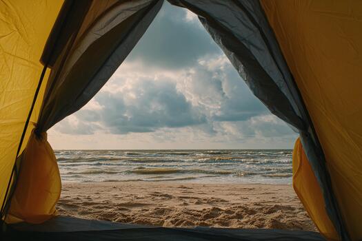 Coastal view from a yellow tent at a beach during cloudy weather photo